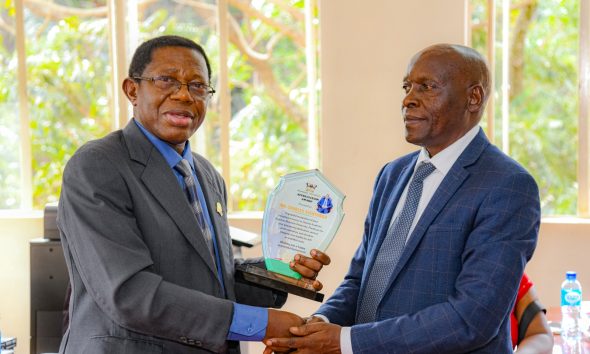 Prof. Buyinza Mukadasi (L) presents an appreciation award to Mr. Charles Ssentongo (R) at his official handover ceremony on 10th September 2026. Mr. Charles Ssentongo official handover of the office of Deputy Academic Registrar – Undergraduate Admissions and Records to Mr. Justus Karegyeya, witnessed by Academic Registrar Prof. Buyinza Mukadasi and Staff, 10th September 2026, Level 3, Senate Building, Makerere University, Kampala Uganda, East Africa.