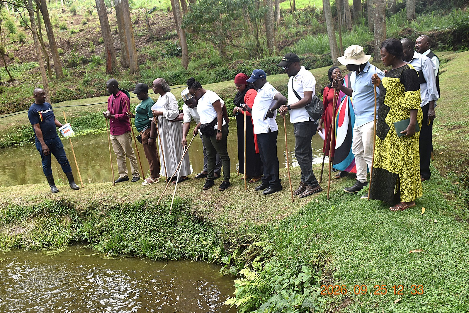 Mr. Bigabwa explaining to the farmers about the fish feeding process. Farmers from Mbale City four-day learning exchange programme in Kasese Municipality and Kabarole District to gain new approaches to strengthening urban food production, 23rd-26th September 2026, supported by the Resilient Urban Food Systems (RUFS) Project, led by Prof. Frank Mugagga, Department of Geography, Geo-Informatics and Climatic Sciences, College of Agricultural and Environmental Sciences (CAES), Makerere University, Kampala Uganda, East Africa.