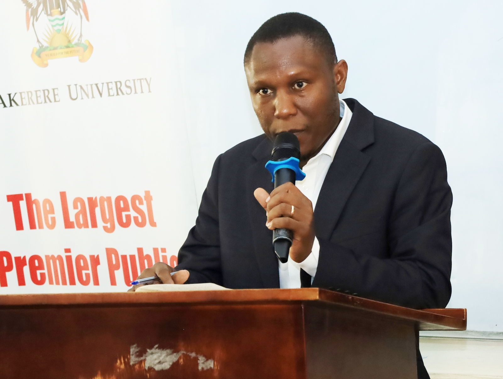 The College Bursar, Mr. Micheal Mbaine giving his remarks. College of Humanities and Social Sciences (CHUSS) orientation of 10 new Gerda Henkel Foundation PhD fellows, CHUSS Smart Room, 7th September 2026, Makerere University, Kampala Uganda, East Africa.