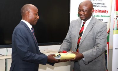 Incoming Deputy Principal CHUSS, Prof. Eddy Joshua Walakira (L) receives one of the Office files from outgoing counterpart Assoc. Prof. Eric Awich Ochen at the handover ceremony on 14th September 2026. Official Handover of Office of Deputy Principal, College of Humanities and Social Sciences (CHUSS), from Associate Prof. Eric Awich Ochen to Prof. Eddy Joshua Walakira, 14th September 2026, CHUSS Smart Room, Makerere University, Kampala Uganda, East Africa.