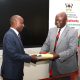 Incoming Deputy Principal CHUSS, Prof. Eddy Joshua Walakira (L) receives one of the Office files from outgoing counterpart Assoc. Prof. Eric Awich Ochen at the handover ceremony on 14th September 2026. Official Handover of Office of Deputy Principal, College of Humanities and Social Sciences (CHUSS), from Associate Prof. Eric Awich Ochen to Prof. Eddy Joshua Walakira, 14th September 2026, CHUSS Smart Room, Makerere University, Kampala Uganda, East Africa.