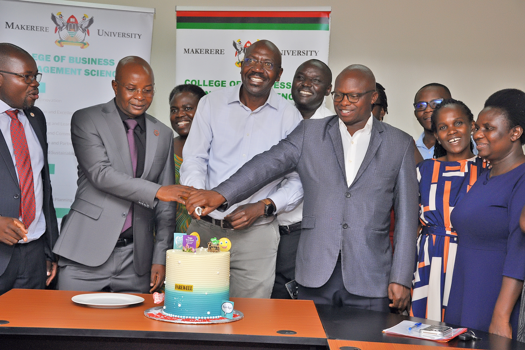 CoBAMS Management and Staff join the Outgoing College Bursar at Official Handover of Office. Mr. Peter Mubiru handover of the office of the College Bursar to Mr. George Lusiba, 31st August 2026, College of Business and Management Sciences (CoBAMS), Makerere University, Kampala Uganda, East Africa.