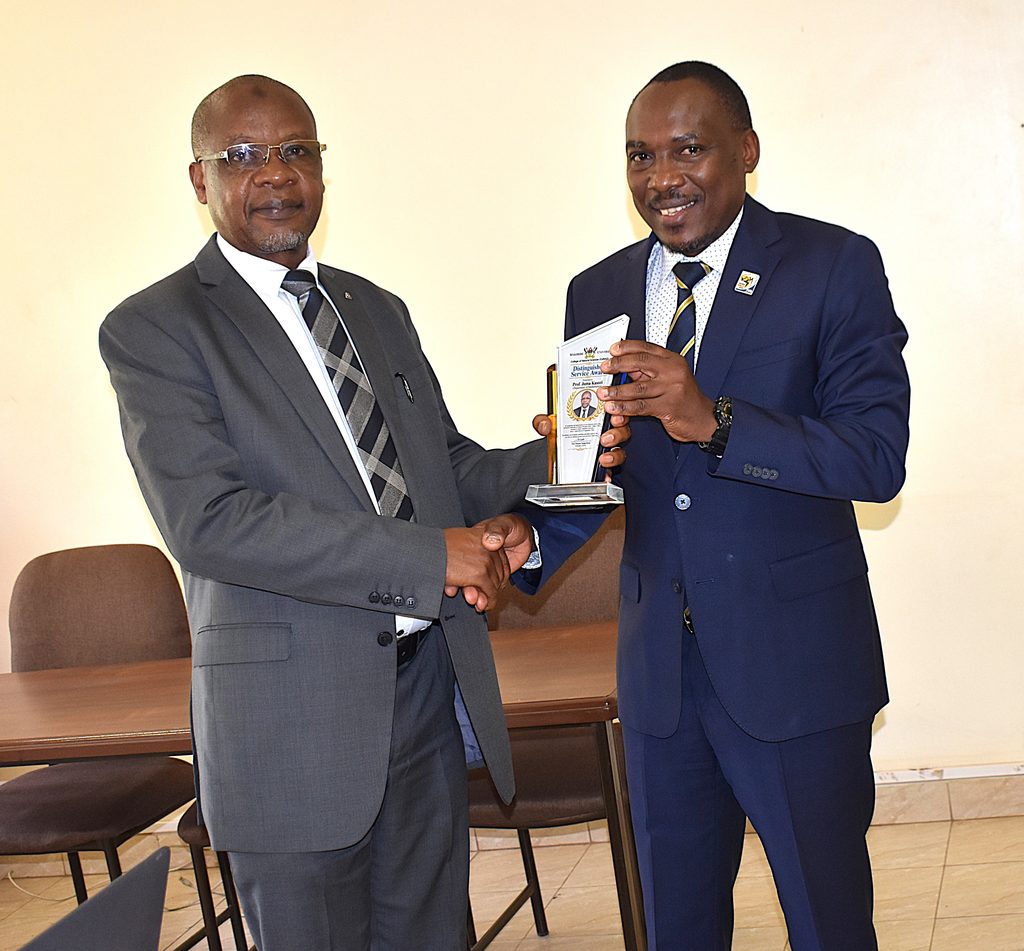 Prof. Ireeta presents a Distinguished Service Award to Prof. Kasozi during the handover ceremony. Prof. Juma Kasozi formally hands over the office of Deputy Principal, College of Natural Sciences (CoNAS) to Prof. Godwin Kakuba, 11th September 2026, Makerere University, Kampala Uganda, East Africa.
