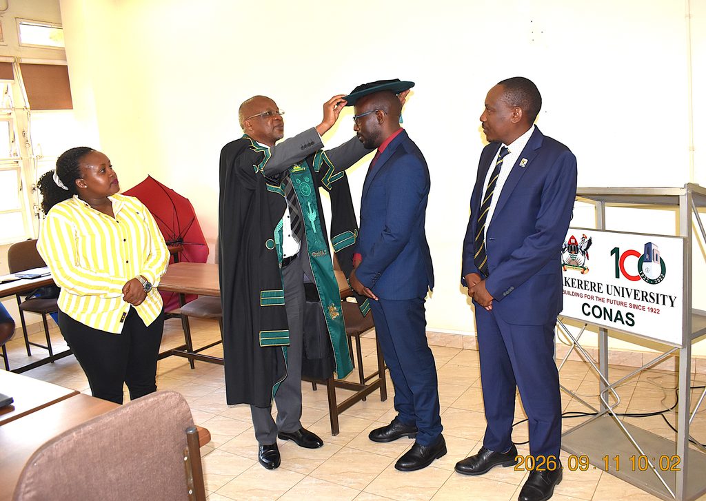 Prof. Kasozi robing Prof. Kakuba in the Deputy Principal’s academic regalia. Prof. Juma Kasozi formally hands over the office of Deputy Principal, College of Natural Sciences (CoNAS) to Prof. Godwin Kakuba, 11th September 2026, Makerere University, Kampala Uganda, East Africa.