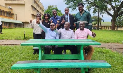 The founders of WastePlus Ltd led by Mr. Sinan Kitagenda with their former Lecturers, Dr. Jamilu E. Ssenku (C) and Dr Samuel Ojelel (R) from the Department of Plant Sciences, Microbiology and Biotechnology, as well as Dr Godfrey Kawooya Kubiriza, Head of the Department of Zoology, Entomology and Fisheries Sciences. The green table is one of the products made by the alumni out of plastic waste WastePlus Ltd, a waste management and recycling enterprise founded by BSc Conservation Biology from the Department of Plant Sciences, Microbiology and Biotechnology, School of Physical Sciences donation of furniture made from recycled plastic, August 2026, Science Quadrangle, College of Natural Sciences (CoNAS), Makerere University, Kampala Uganda, East Africa.