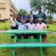 The founders of WastePlus Ltd led by Mr. Sinan Kitagenda with their former Lecturers, Dr. Jamilu E. Ssenku (C) and Dr Samuel Ojelel (R) from the Department of Plant Sciences, Microbiology and Biotechnology, as well as Dr Godfrey Kawooya Kubiriza, Head of the Department of Zoology, Entomology and Fisheries Sciences. The green table is one of the products made by the alumni out of plastic waste WastePlus Ltd, a waste management and recycling enterprise founded by BSc Conservation Biology from the Department of Plant Sciences, Microbiology and Biotechnology, School of Physical Sciences donation of furniture made from recycled plastic, August 2026, Science Quadrangle, College of Natural Sciences (CoNAS), Makerere University, Kampala Uganda, East Africa.