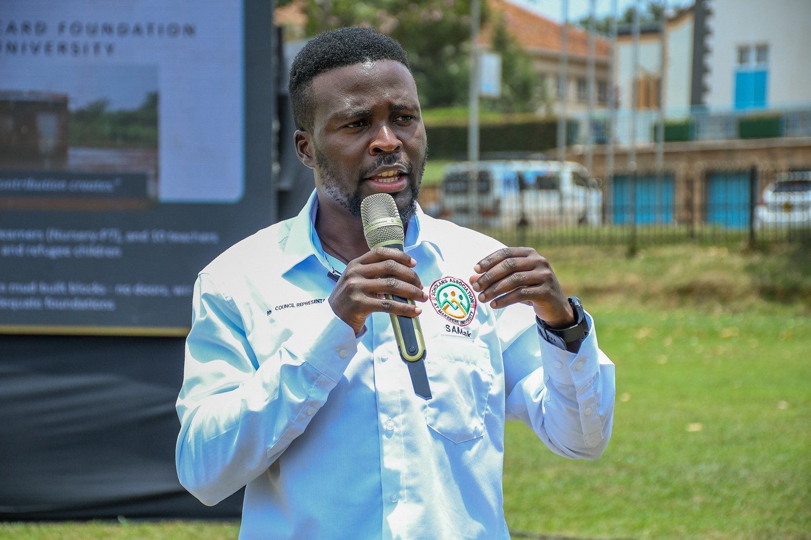 Elphas Khamala, the Mastercard Foundation Scholars Council representative speaking at the event. Community Open Day for Mastercard Foundation Initiatives at Makerere University, where Prof. Claire Mack Mugasa represented the Deputy Vice Chancellor (Academic Affairs) Prof. Sarah Ssali as Guest of Honour, 5th September 2026, Freedom Square, Kampala Uganda, East Africa.