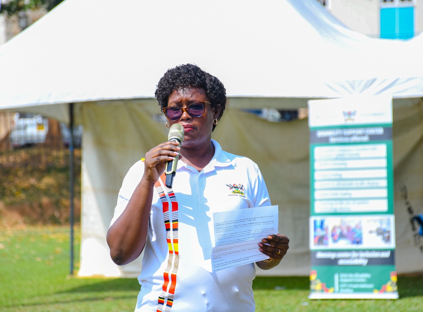 Ms. Jolly Okumu, who represented the Program Director, Prof. Justine Namaalwa, speaking at the event. Community Open Day for Mastercard Foundation Initiatives at Makerere University, where Prof. Claire Mack Mugasa represented the Deputy Vice Chancellor (Academic Affairs) Prof. Sarah Ssali as Guest of Honour, 5th September 2026, Freedom Square, Kampala Uganda, East Africa.