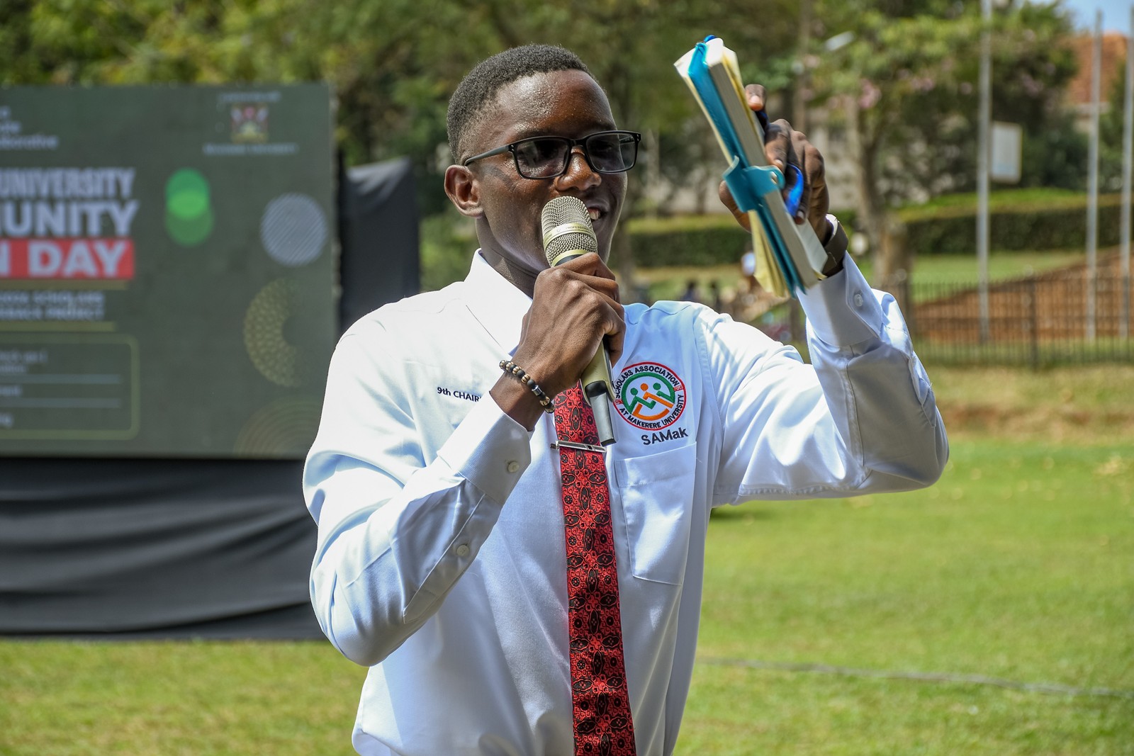 Paul Wandera, the Chairperson of the Scholars Association addressing the gathering during the event. Community Open Day for Mastercard Foundation Initiatives at Makerere University, where Prof. Claire Mack Mugasa represented the Deputy Vice Chancellor (Academic Affairs) Prof. Sarah Ssali as Guest of Honour, 5th September 2026, Freedom Square, Kampala Uganda, East Africa.