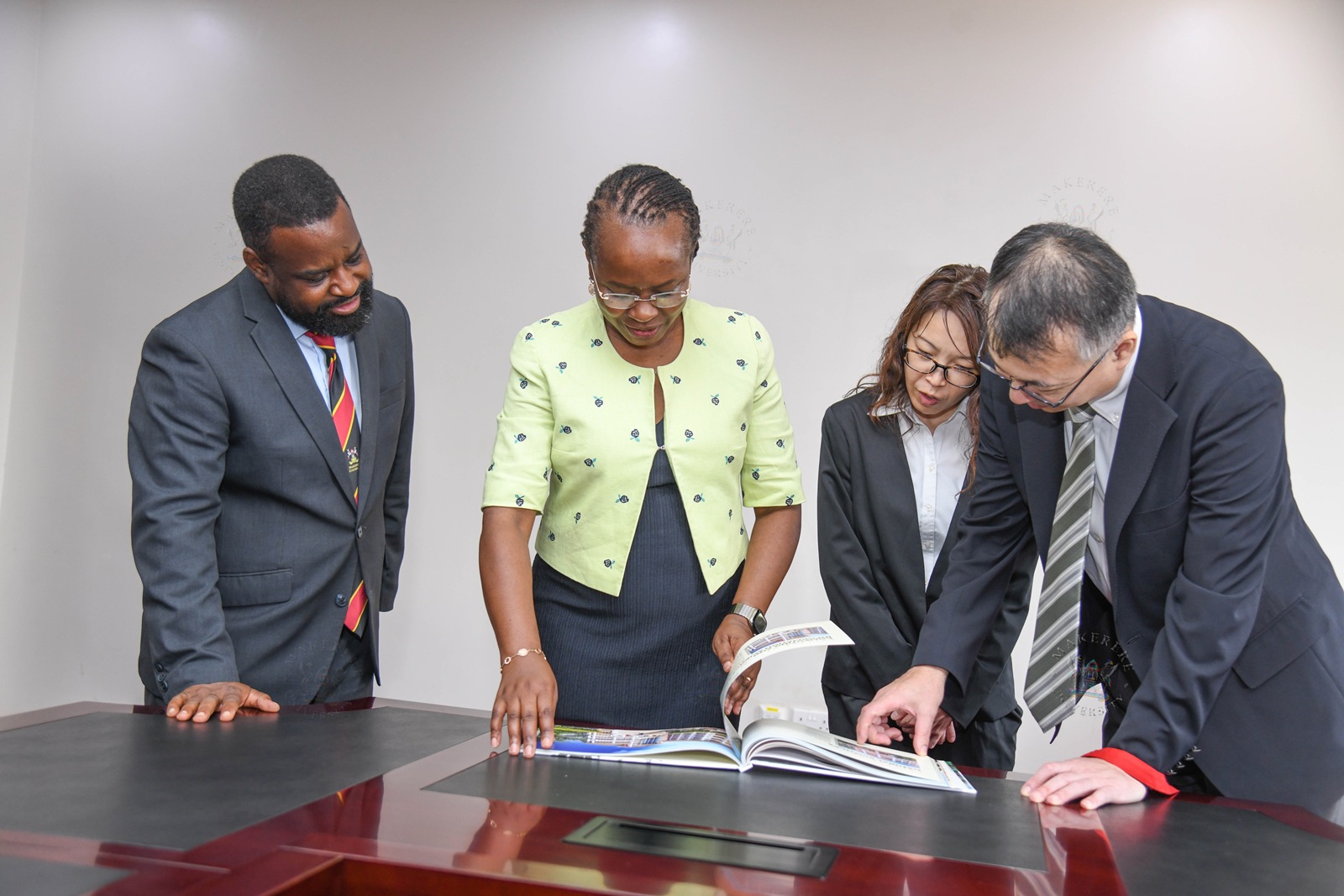 L-R: Prof. Robert Wamala, Prof. Sarah Ssali, Ms. Eri Maeda and Dr. Okano Takasei flip through the Makerere Coffee Table book. Japan International Cooperation Agency (JICA) delegation led by Dr. Okano Takasei meets DVCAA Prof. Sarah Ssali, explores new opportunities for strengthening academic, research and innovation collaboration between Uganda, Japan and other African countries, with a particular focus on artificial intelligence (AI), aerospace engineering, materials and remote sensing, food value chains, energy, water and climate change, 4th September 2026, Main Building, Makerere University, Kampala Uganda, East Africa.