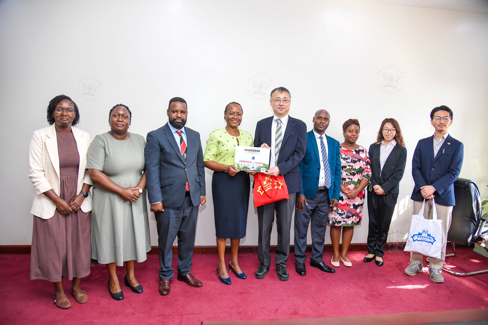 Prof. Sarah Ssali presents the Makerere coffee table book to Dr. Okano Takasei as Makerere and JICA Officials witness on 4th September 2026. Japan International Cooperation Agency (JICA) delegation led by Dr. Okano Takasei meets DVCAA Prof. Sarah Ssali, explores new opportunities for strengthening academic, research and innovation collaboration between Uganda, Japan and other African countries, with a particular focus on artificial intelligence (AI), aerospace engineering, materials and remote sensing, food value chains, energy, water and climate change, 4th September 2026, Main Building, Makerere University, Kampala Uganda, East Africa.