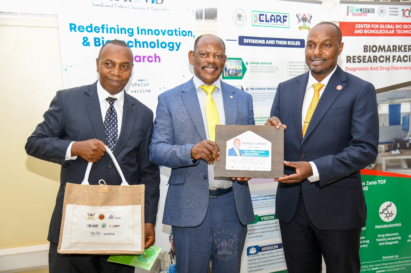 The Vice Chancellor, Prof. Barnabas Nawangwe, together with CoVAB Principal, Prof. Clovice Kankya, present gifts to the Minister for Science, Technology and Innovation, Rt. Hon. Eng. Asiimwe Jonard, in recognition of his maiden visit to Makerere University. Hon. Eng. Jonard Asiimwe Akiiki, Minister of Science, Technology and Innovation in the Office of the President, Day 3 of Ministerial Maiden Visit to Makerere University, 16th September 2026, Centre for Global Biosecurity and Biomolecular Technology (CeBioTech), College of Veterinary Medicine, Animal Resources and Biosecurity (CoVAB), Kampala Uganda, East Africa.