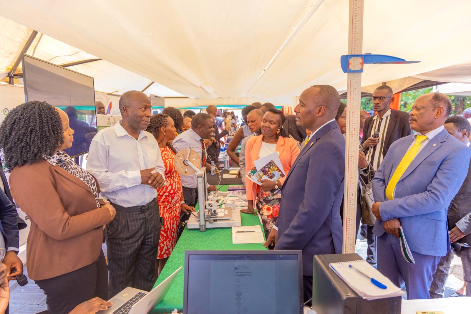 Prof. Noah Kiwanuka briefs Hon. Eng. Jonard Asiimwe Akiiki and VC Prof. Barnabas Nawangwe during the MakSPH research exhibition. Hon. Eng. Jonard Asiimwe Akiiki, Minister of Science, Technology and Innovation in the Office of the President, Day 3 of Ministerial Maiden Visit to Makerere University, 16th September 2026, Kampala Uganda, East Africa.