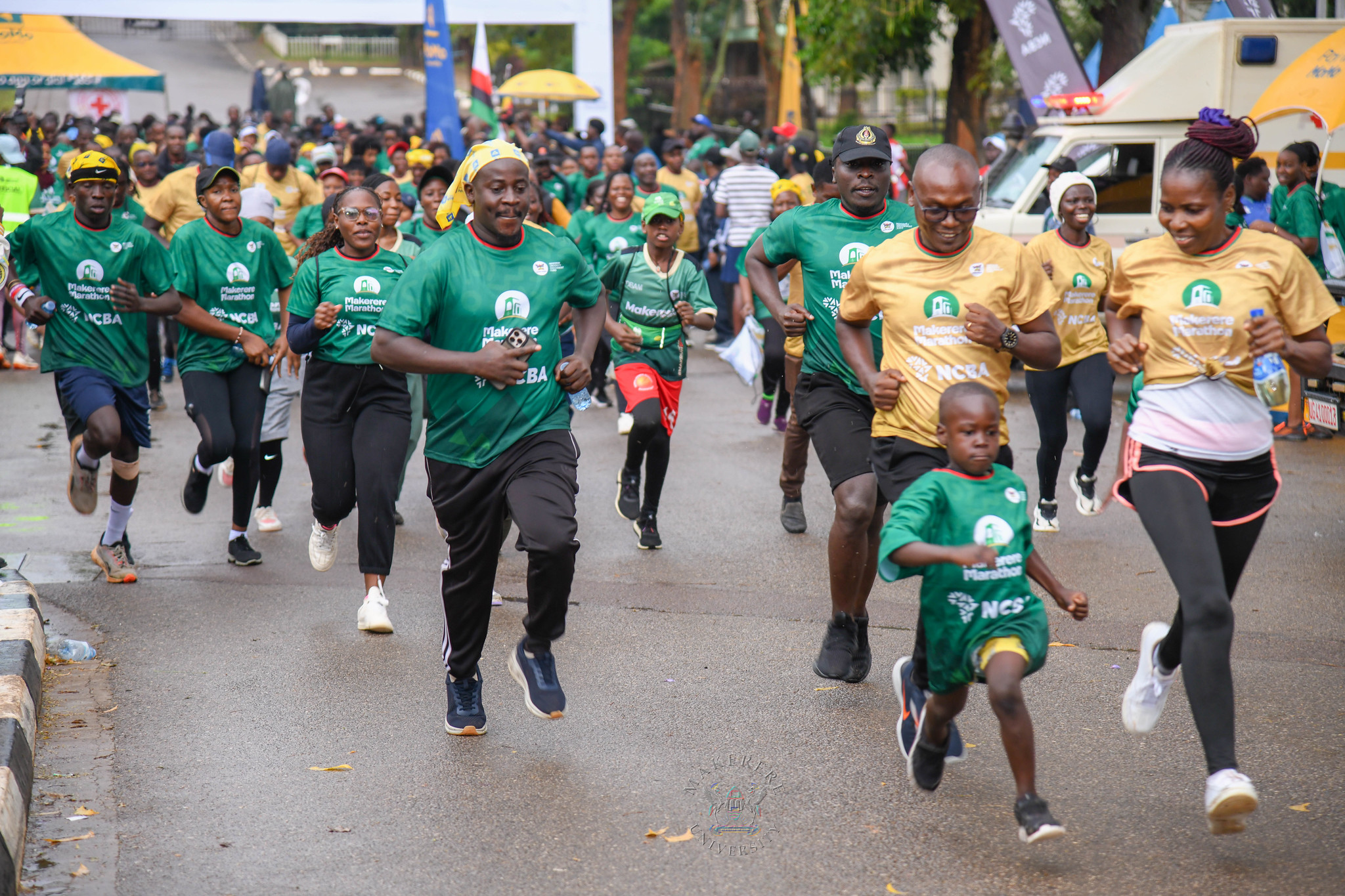 Runners, both young and old, in green and gold kits race off the start line. 6th Edition of the Makerere Marathon with Chief Runner as the Speaker of Parliament Rt. Hon. Jacob Marksons Oboth, 27th September 2026, Makerere University, Kampala Uganda, East Africa.