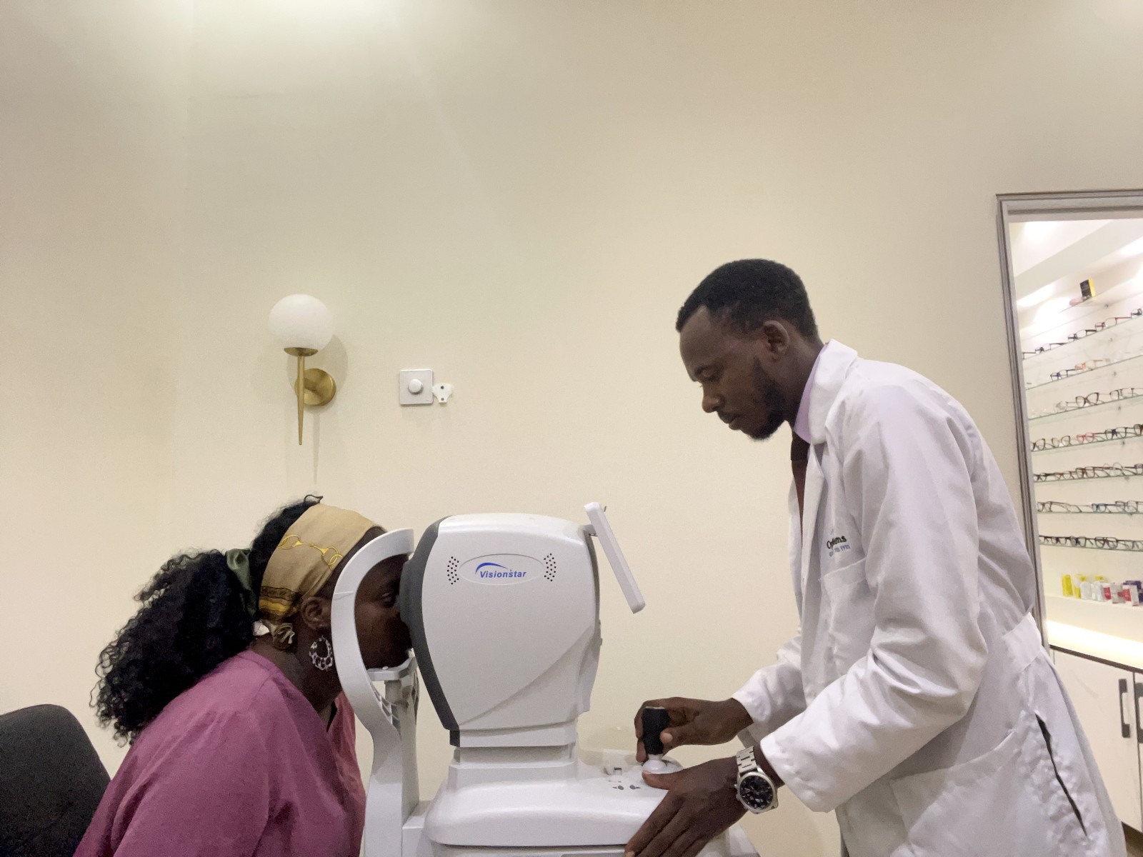 Khabusi Timothy examining one his patients at his eye clinic. Impact Stories: Timothy Khabusi, Mastercard Foundation Scholars Program alumnus, optometrist, researcher, programmer, and eye health entrepreneur, on an ambitious mission to improve eye health in Uganda, October 2026, Makerere University, Kampala Uganda, East Africa.