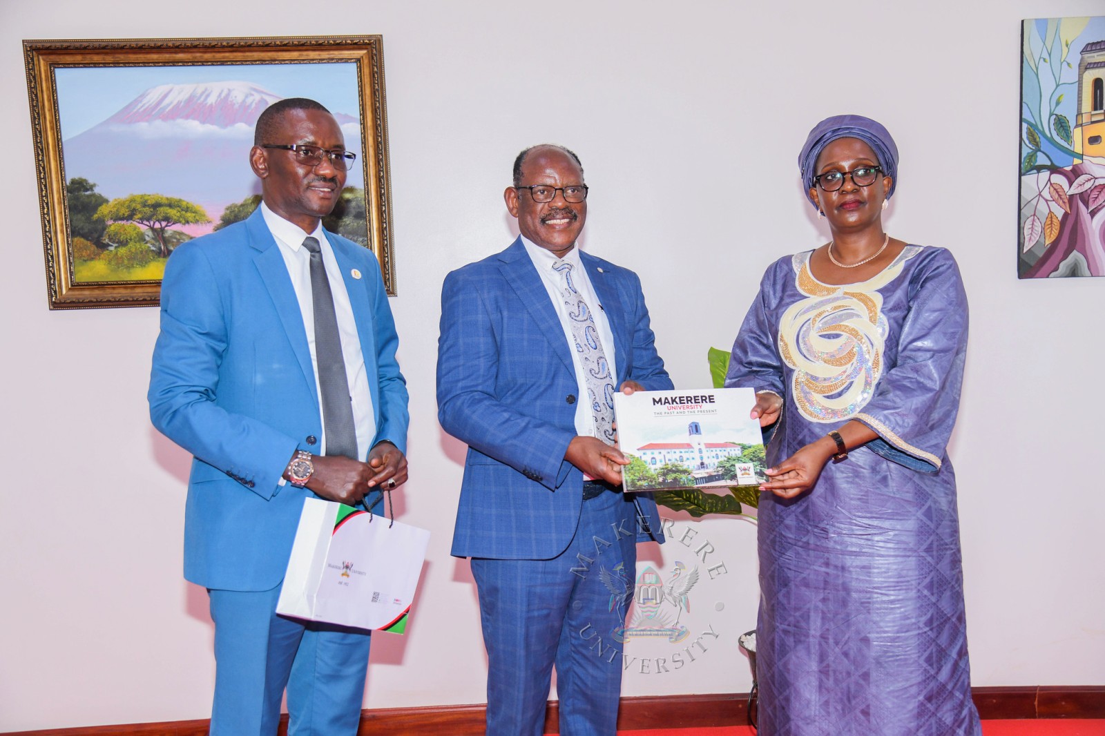 Prof. Nawangwe (C) presents the Makerere@100 Coffee Table Book to Mrs. Twinomugisha Muhairwe (R) as Mr. Kakooza Savio Ntensibe (L) witnesses. Makerere University welcomed Mrs. Anne Twinomugisha Muhairwe, the Deputy Inspector General of Government (DIGG) and her delegation for a courtesy visit ahead of the International Ombuds Day 2026 commemoration under the theme “Ombuds: Office of Options”, 5th October 2026, Main Building, Makerere University, Kampala Uganda, East Africa.
