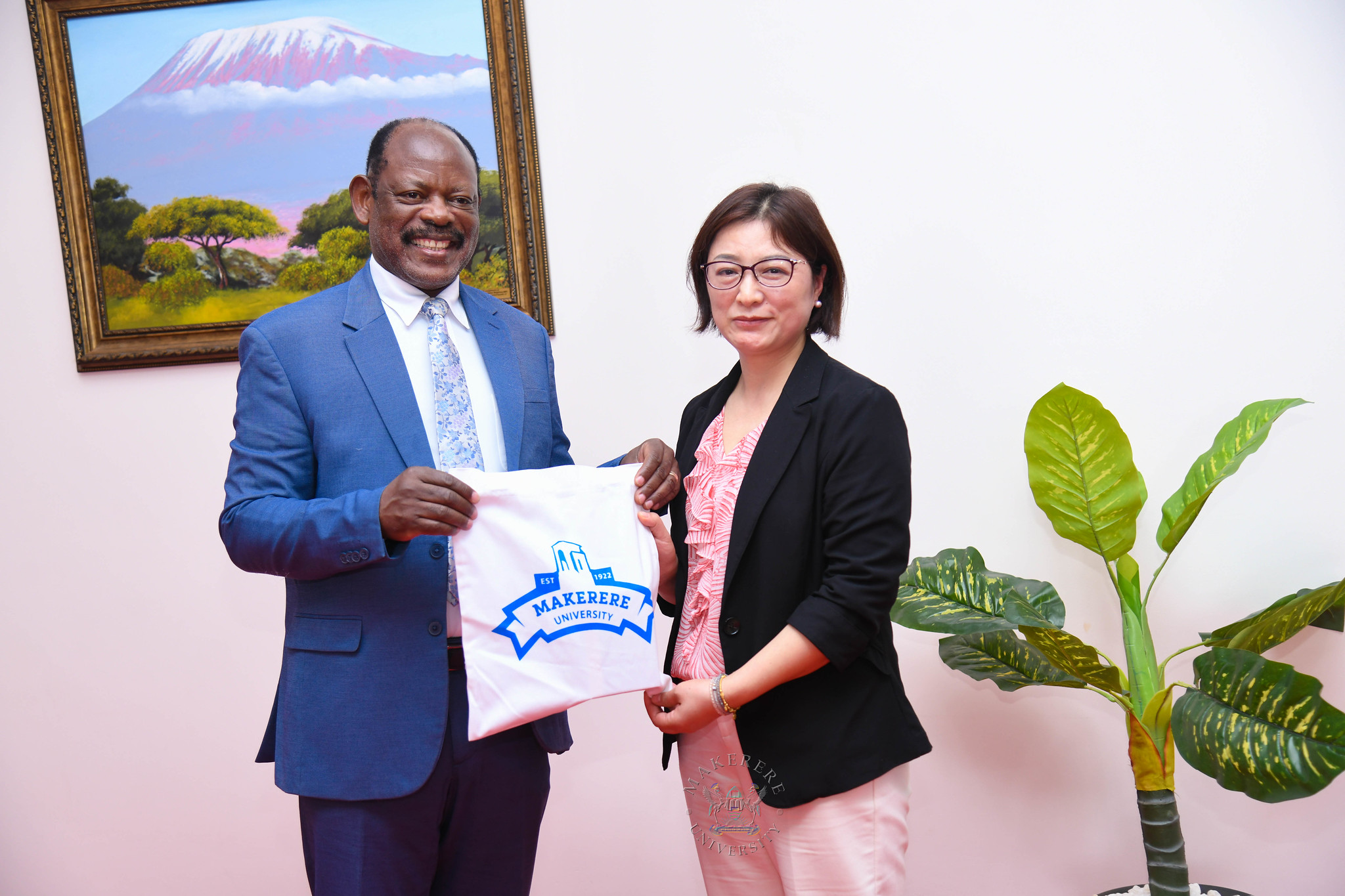 Prof. Barnabas Nawangwe (L) presents an assortment of Makerere Souvenirs to Prof. Zhuoqiong Xia (R). Visit by a delegation from Xiangtan University headed by Professor Dingyu Ou, in company of Mr. Tang Fei and Professor Gilbert Gumshabe, the Chinese and Ugandan Directors of the Confucius Institute at Makerere University respectively, to update 20-year academic partnership, with new focus on joint Master's degree program in Chemical Engineering 12th October 2026, French Embassy, Kampala Uganda, East Africa.