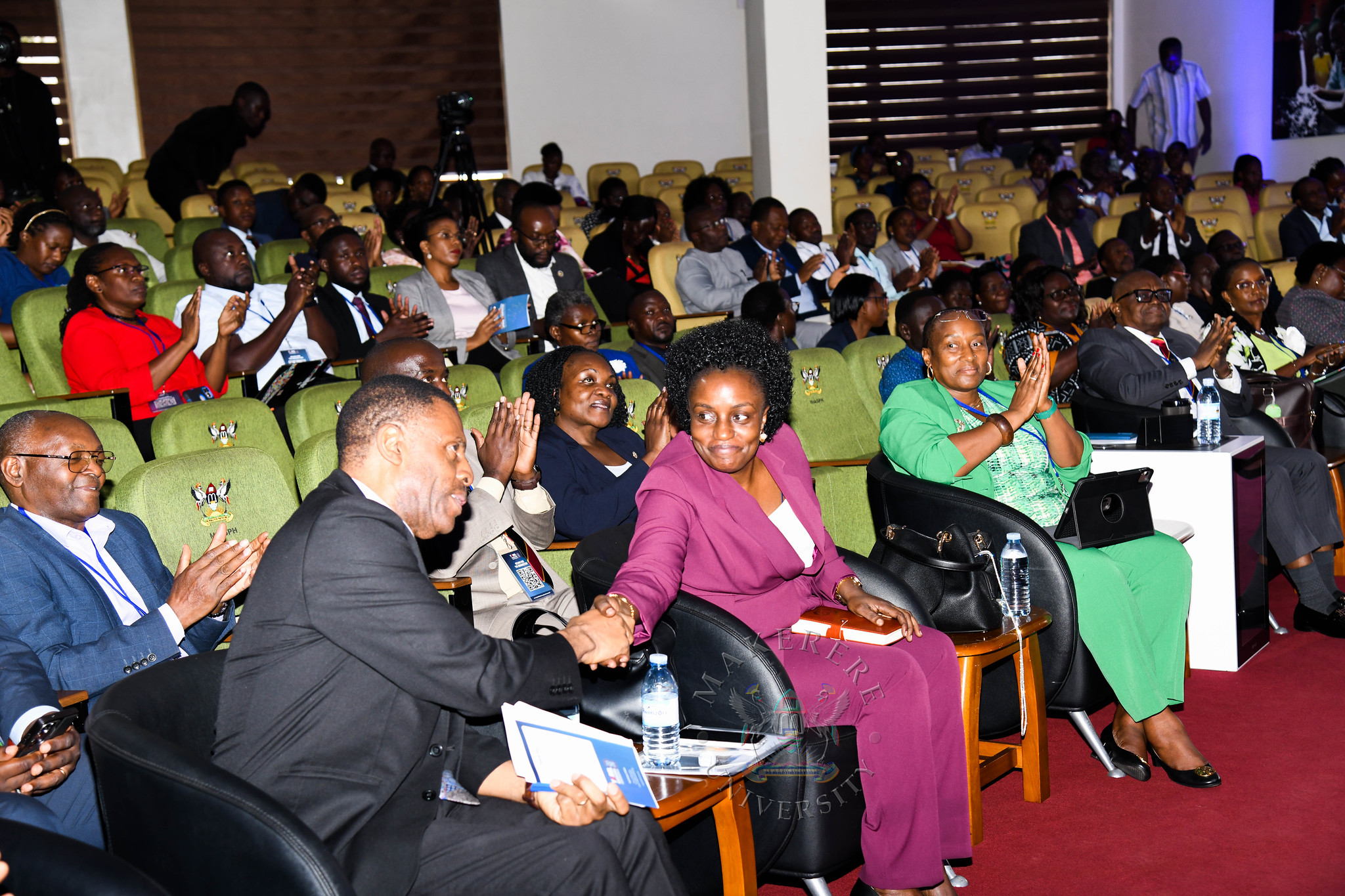 Ms. Doreen Katangaza shakes hands with Dr. James Magara after his keynote address. YOBEL Biashara Conference 2026, theme: Africa's Agency in an Era of Geopolitical Change-Trade, Investment and Economic Transformation, Makerere University School of Public Health Auditorium, 30th September 2026, Makerere University, Kampala Uganda, East Africa.