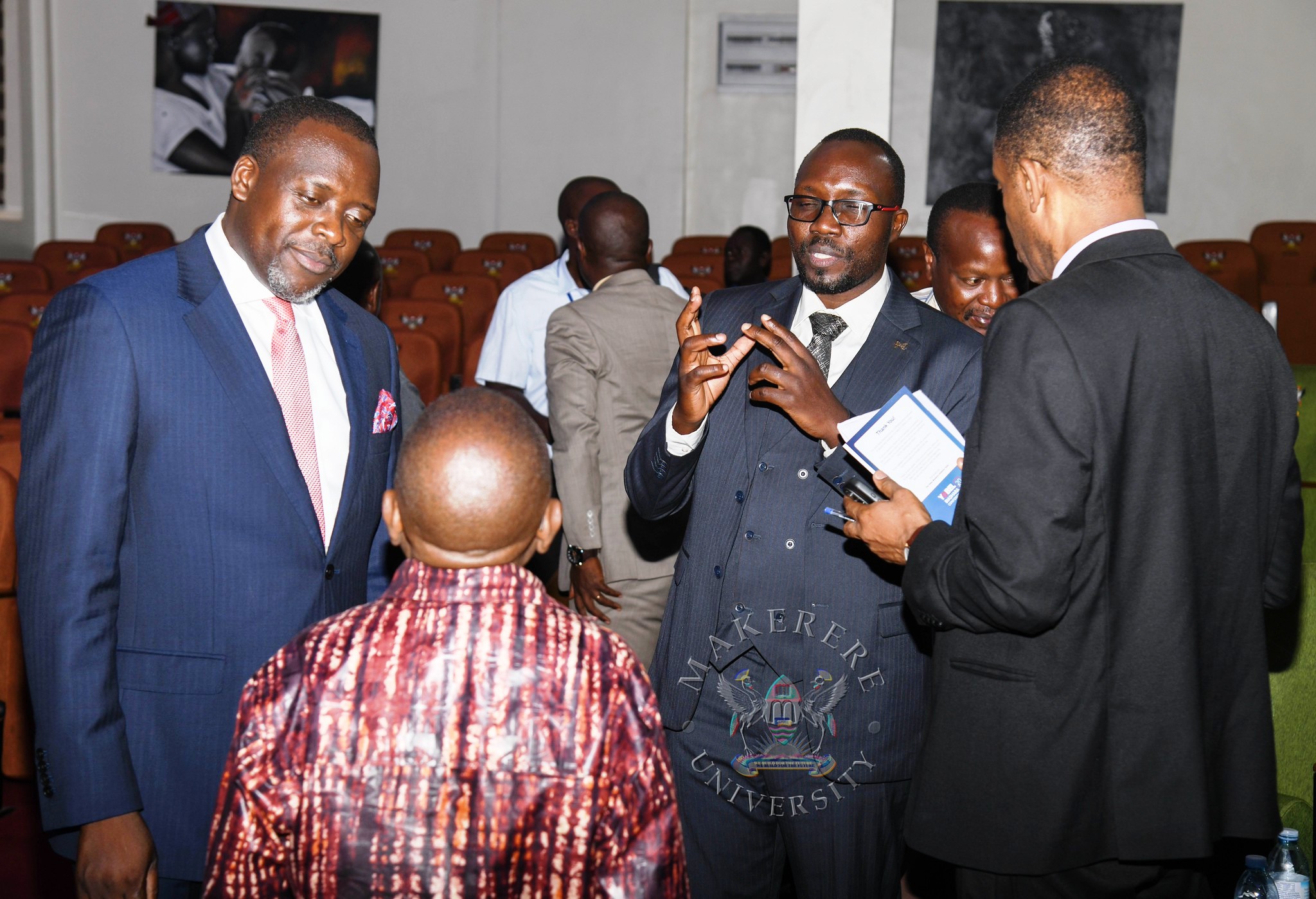 University Secretary-Mr. Yusuf Kiranda (L) and other attendees interact with Dr. James Magara at the Conference. YOBEL Biashara Conference 2026, theme: Africa's Agency in an Era of Geopolitical Change-Trade, Investment and Economic Transformation, Makerere University School of Public Health Auditorium, 30th September 2026, Makerere University, Kampala Uganda, East Africa.