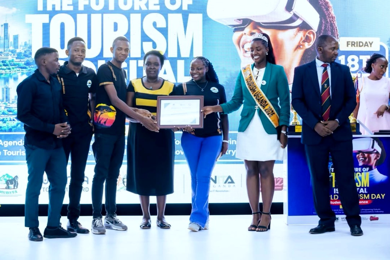 The tourism students receiving a certificate in recognition of their performance. Courtesy Photo. Makerere University Students Win Inter-University tourism quiz that tested students’ knowledge of tourism, Ugandan culture and heritage, as well as their ability to interpret photographic representations of tourism attractions at the Ministry of Tourism, Wildlife and Antiquities, Makerere University Business School (MUBS) and the Uganda Tourism Board workshop on theme “ Digital agenda, artificial intelligence to redesign tourism", 18th September 2026, Makerere University Business School (MUBS), Kampala Uganda, East Africa.